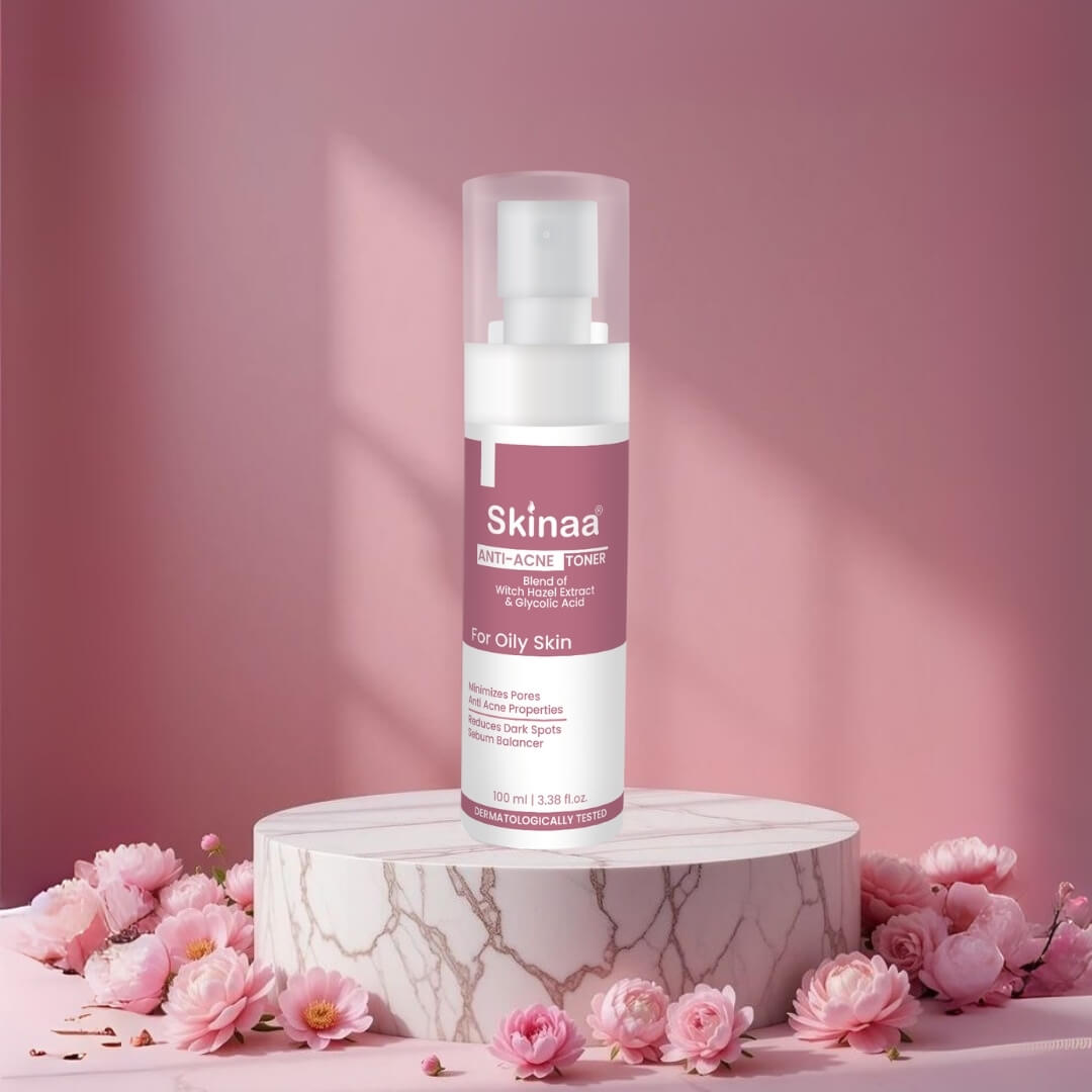 Skinaa Anti-Acne Toner for oily skin – dermatologically tested toner with witch hazel and salicylic acid, beautifully displayed on a marble platform with pink floral background