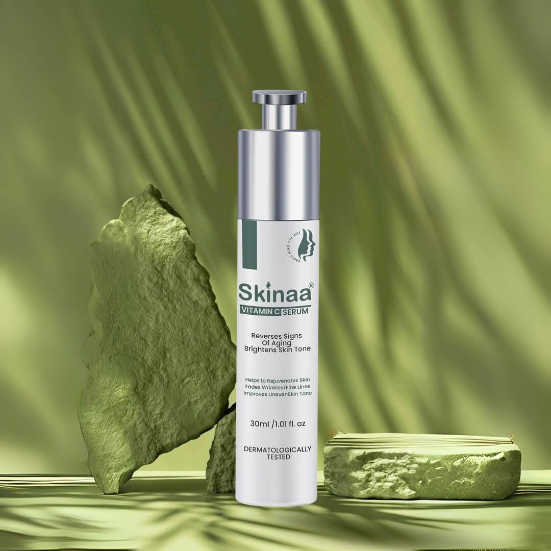 Skinaa Vitamin C Serum bottle with green natural stone background, formulated for glowing skin, anti-aging, and brightening uneven skin tone